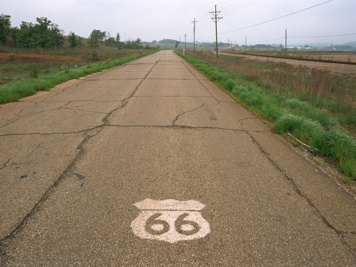 Old road with cracks and route 66 sign