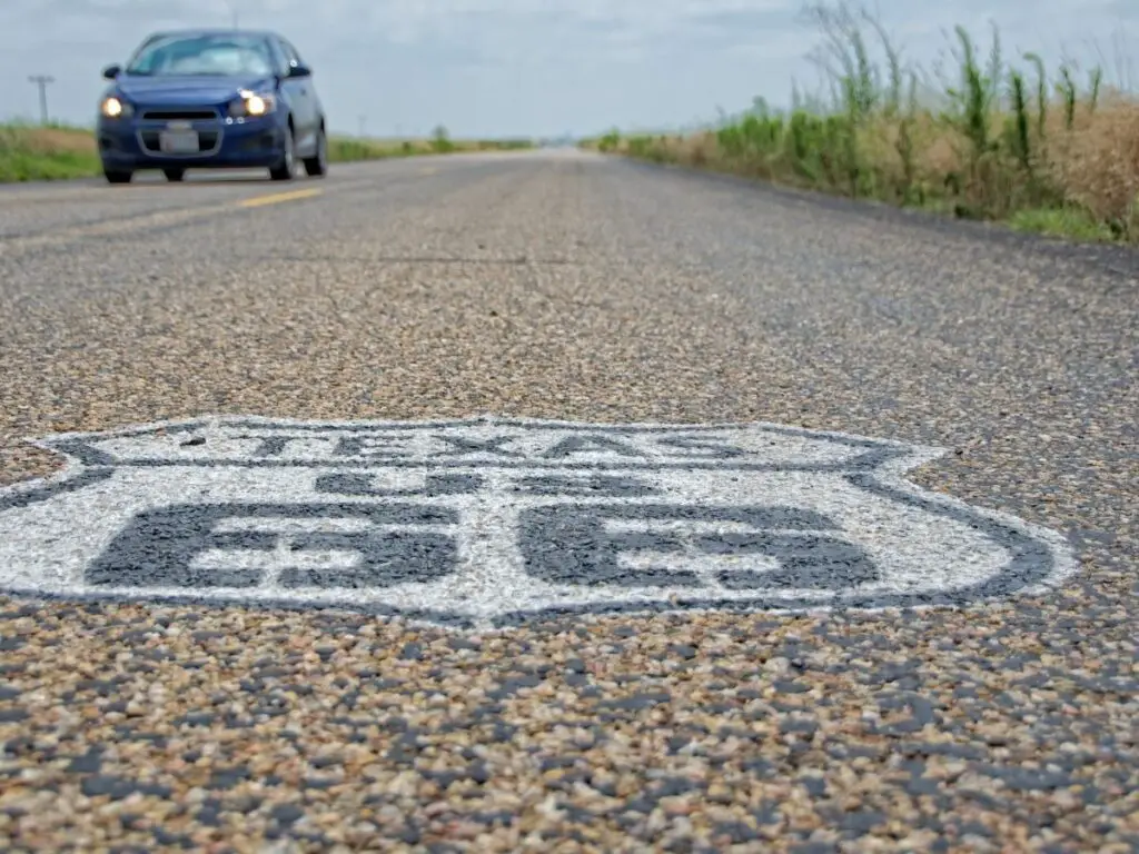 car on route 66 with sign