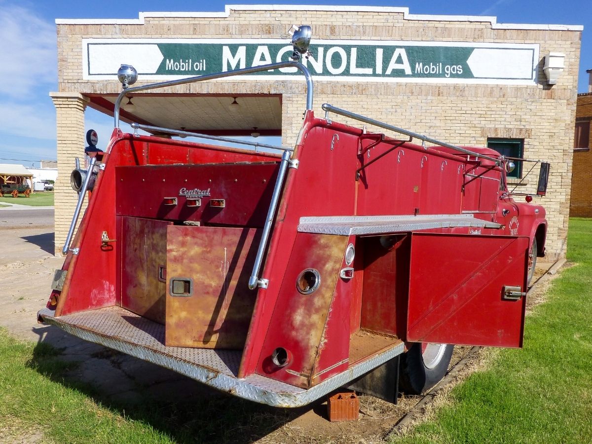 Old fire truck outside vintage gas station on Route 66 in Texas