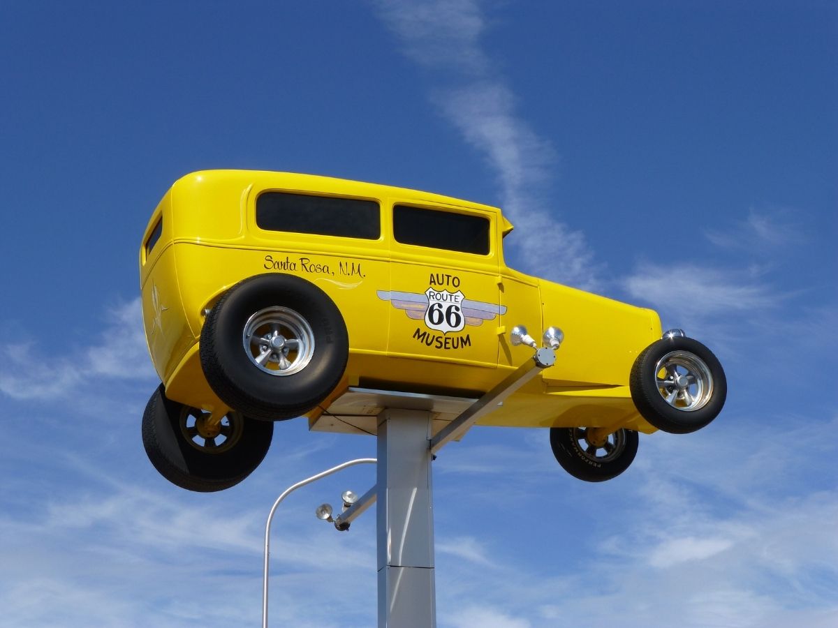 Yellow car advertising a museum on Route 66 in New Mexico