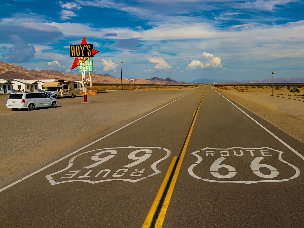 Road and old motels sign along Route 66 in California