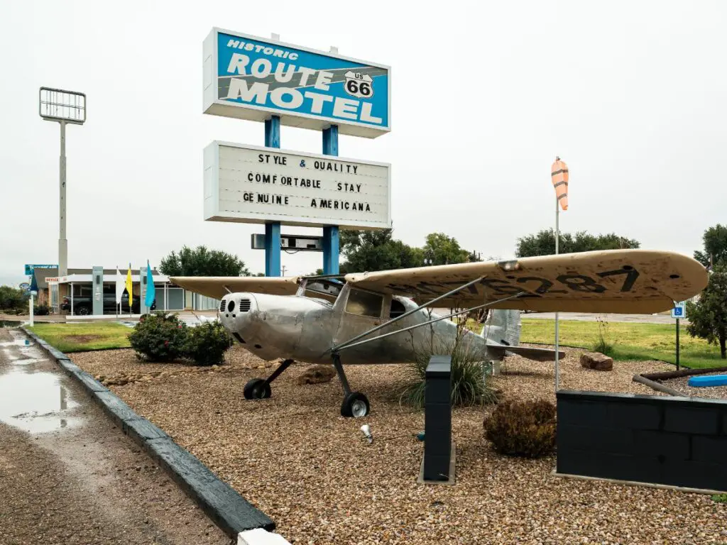 airplane in front of a Route 66 motel sign in Tucumcari New Mexico